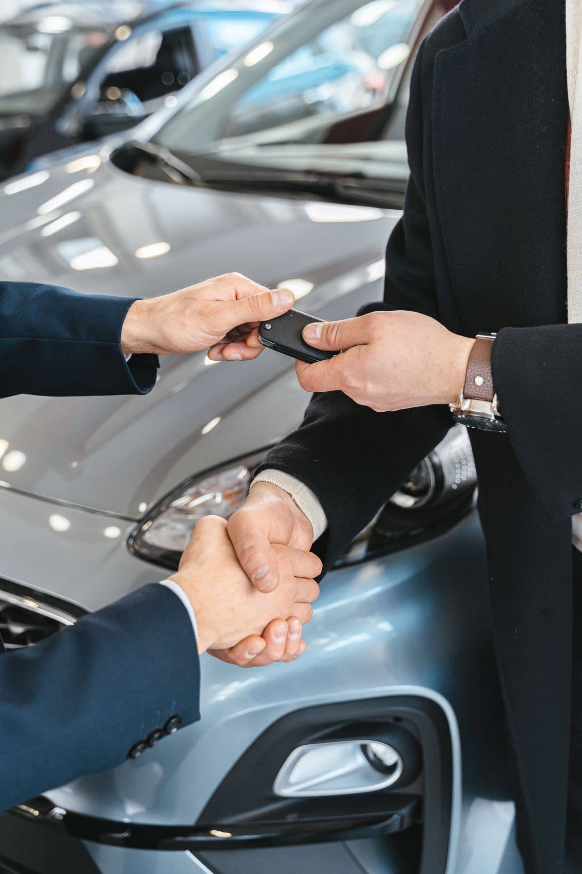Car keys being handed from one person to another